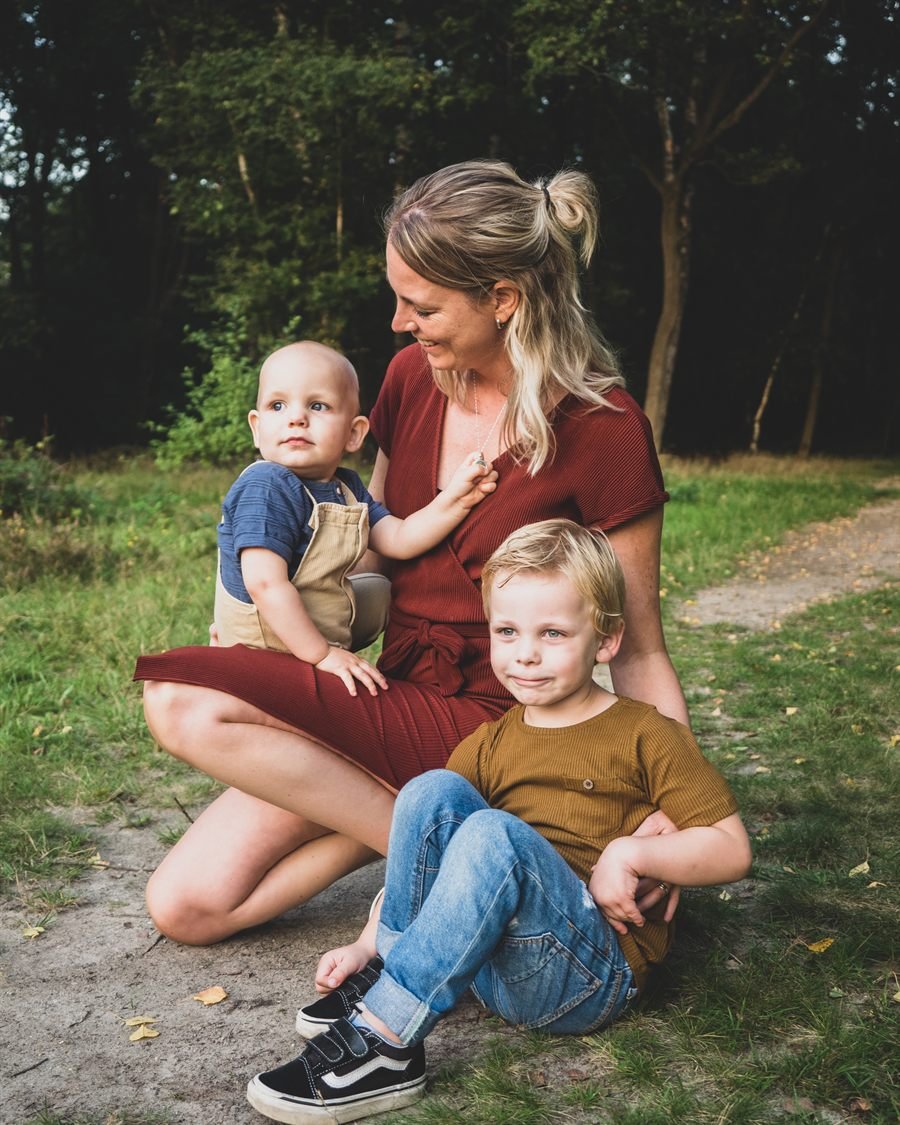 Yanieke zit op een bospad met haar twee jonge zoons bij zich.